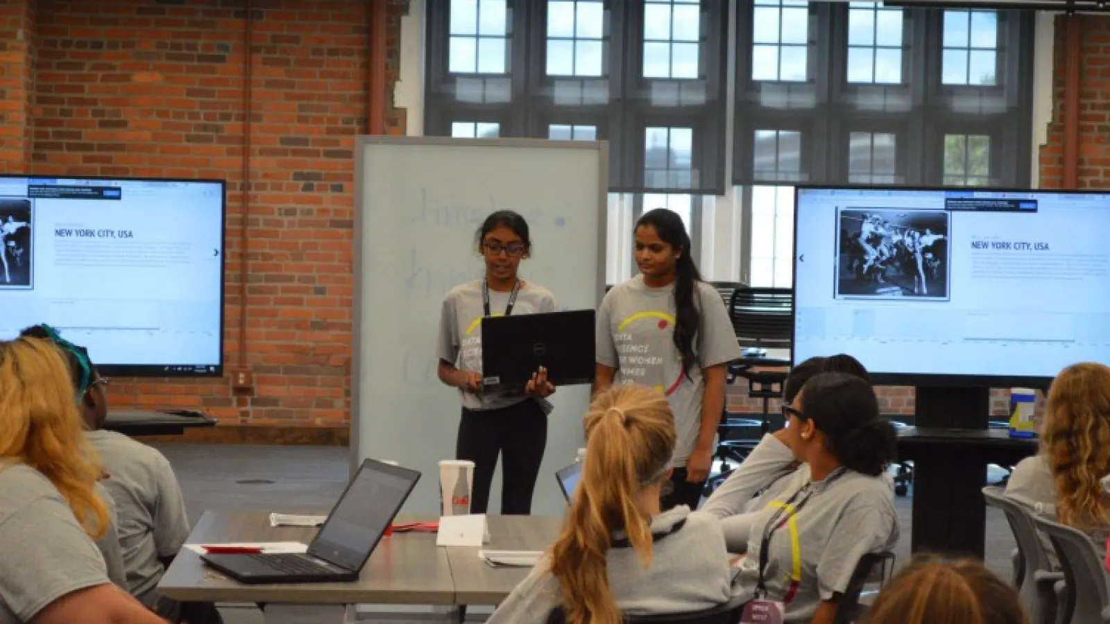 Photo of summer camp attendees presenting their work