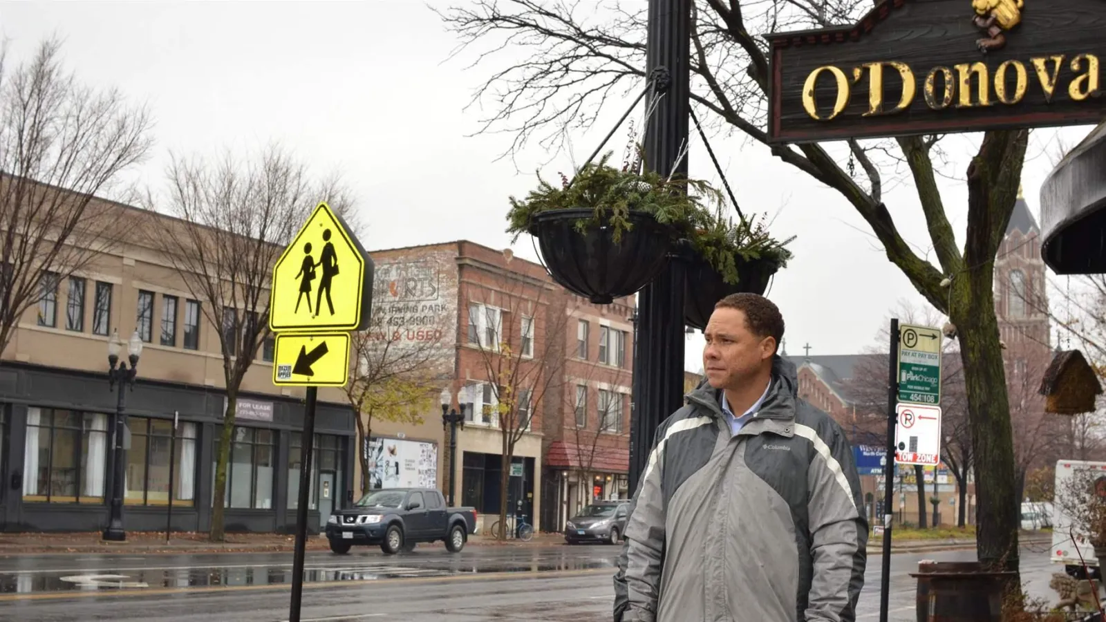 Man in front of crosswalk sign 