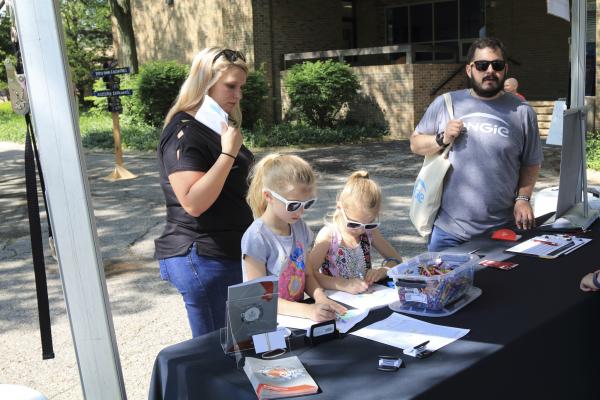 A family enjoying the hands-on mapping activity designed by CURA